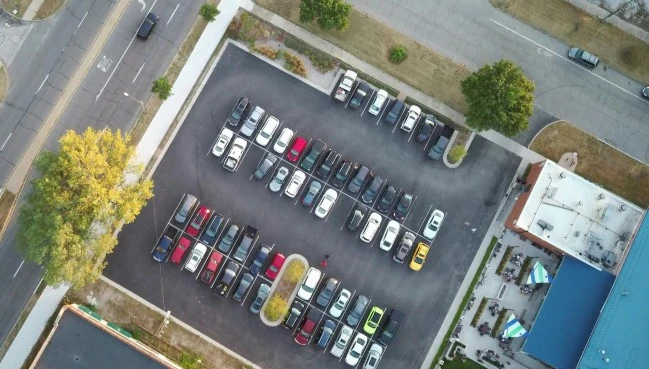 A full commercial parking lot with every space occupied, illustrating the overstay problem for small businesses