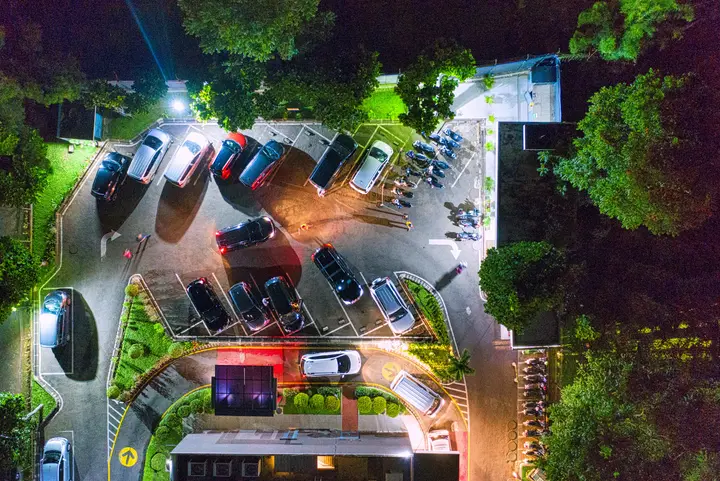 A parking lot at night, illustrating the challenge of overnight parking enforcement at multifamily properties